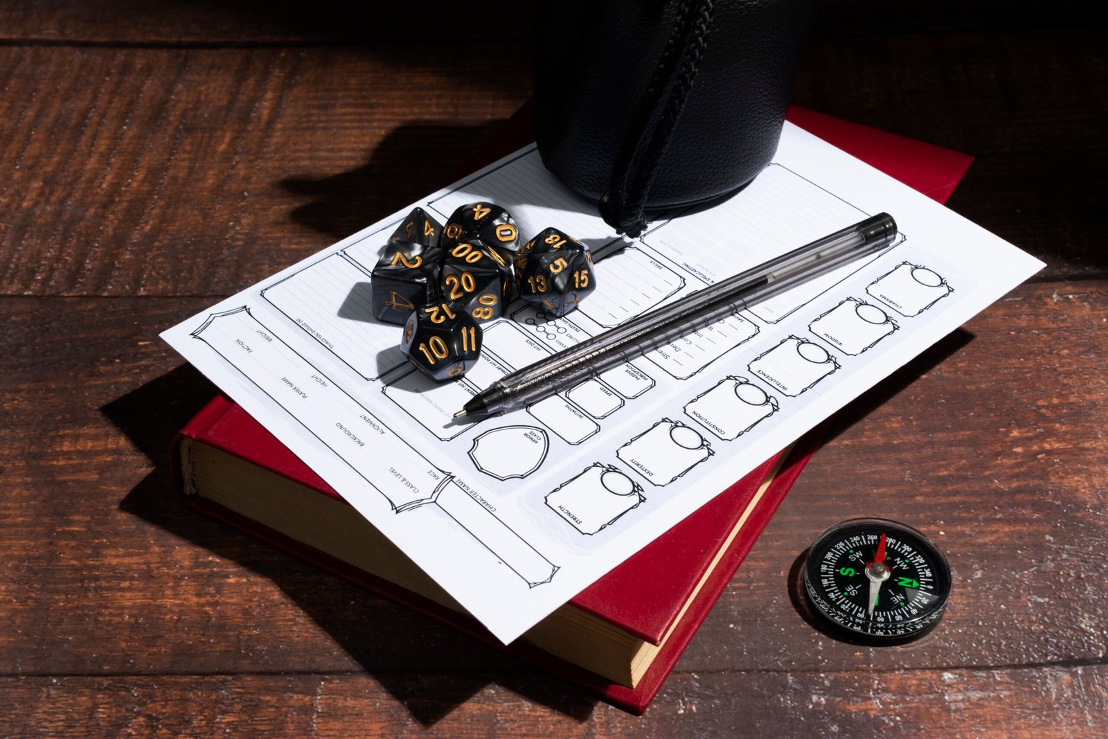 Tabletop role-playing game sheet with dice and pen